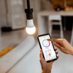 Person controlling smart bulb via app