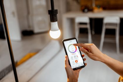 Person controlling smart bulb via app