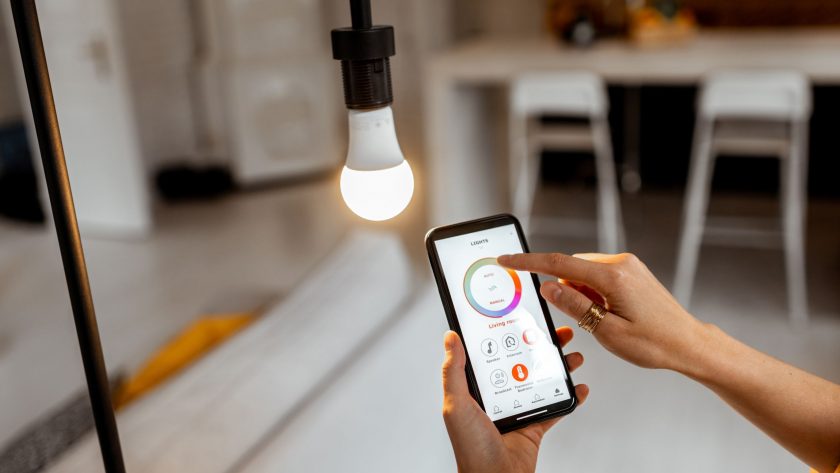 Person controlling smart bulb via app