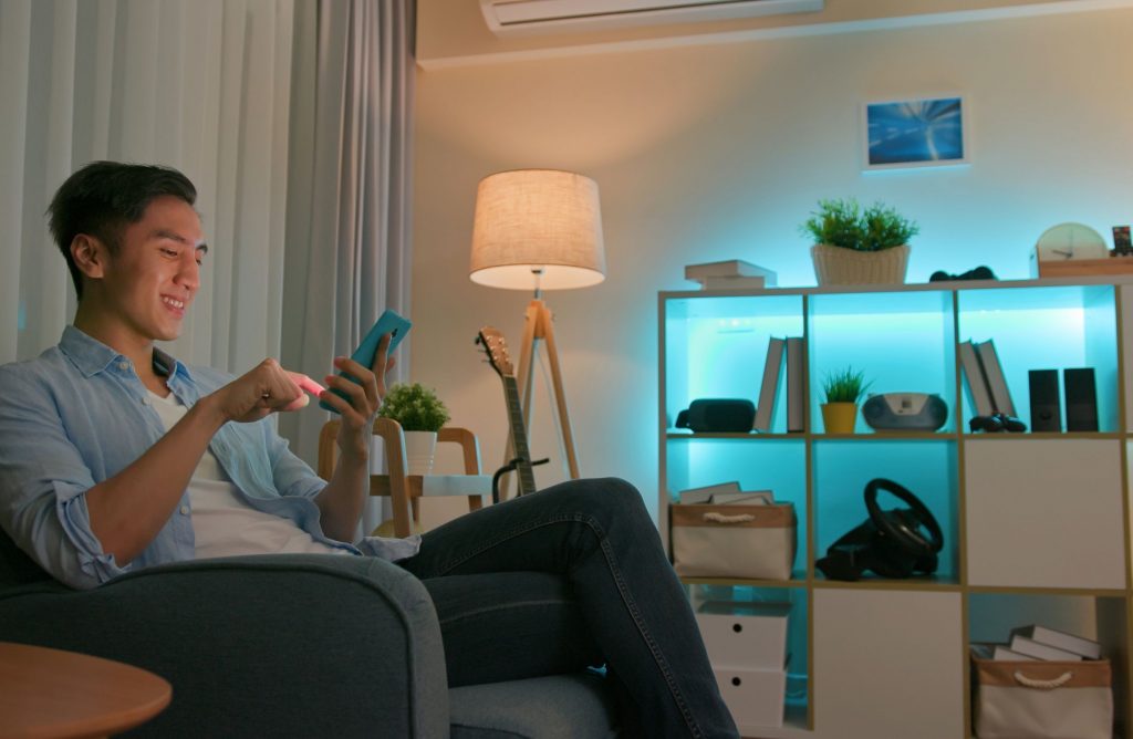 Person controlling smart lighting from their phone