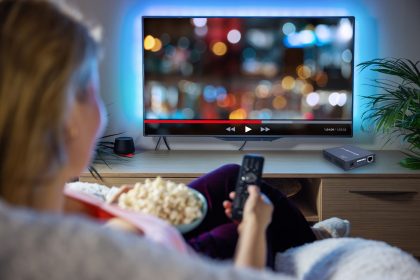 Woman watching TV over HDMI extender signal