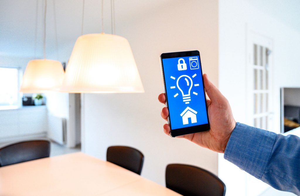 Person controlling their smart bulb via their phone