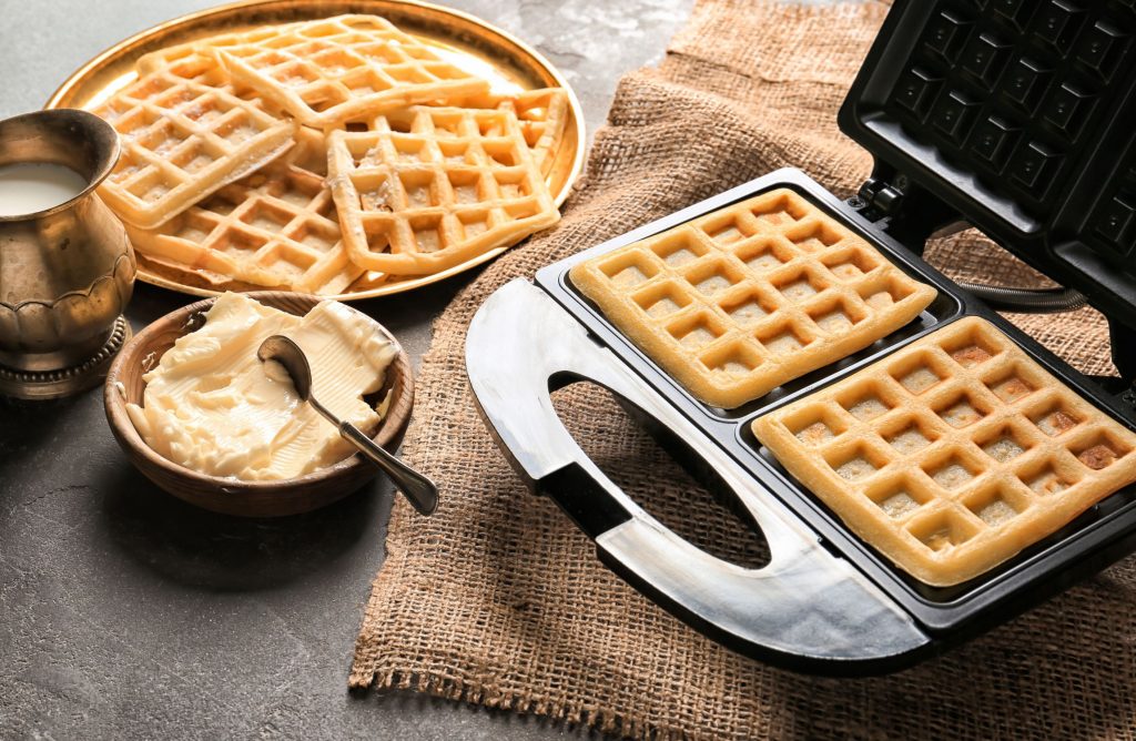A waffle maker with delicious golden waffles