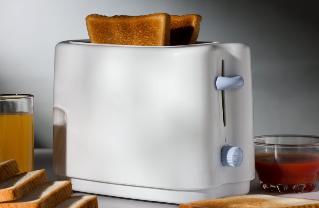 A toaster with perfectly cooked slices of toast