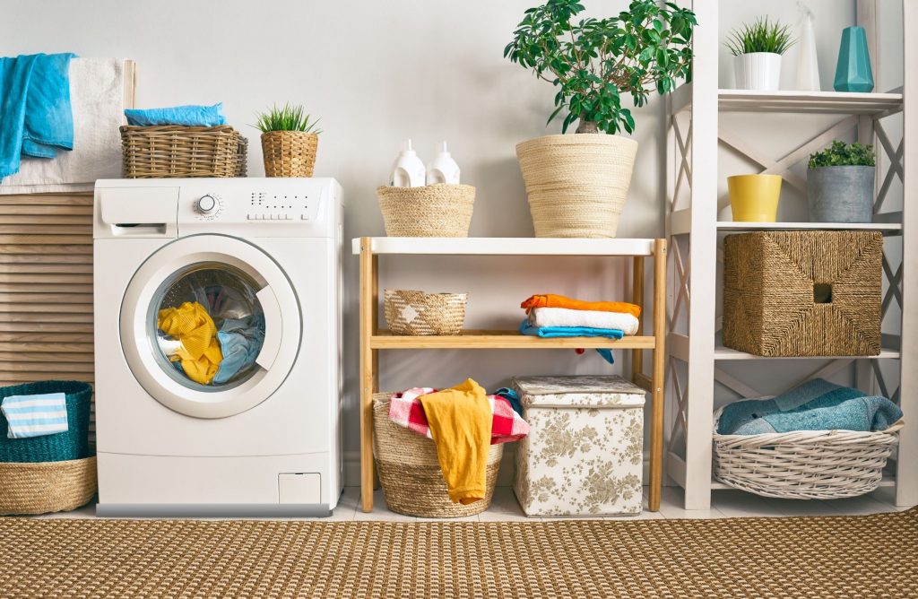 Washing machine in a laundry room with drip tray underneath